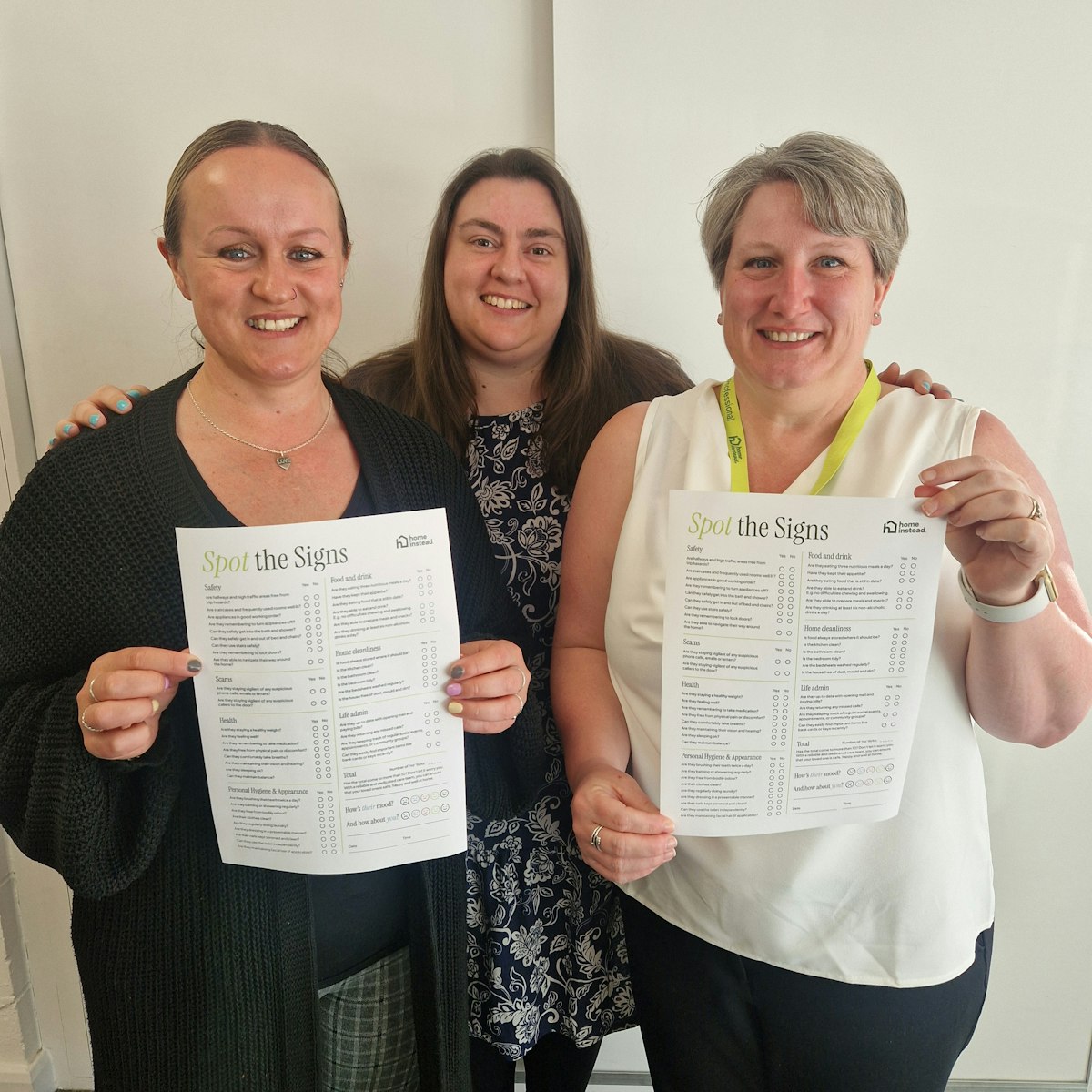 The Home Instead Ipswich, Felixstowe & Woodbridge team holding the Spot the Signs checklist